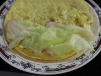 Az omlettet ráhelyezzük a tortilla lapra. A...